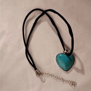 Turquoise heart necklace on cord.